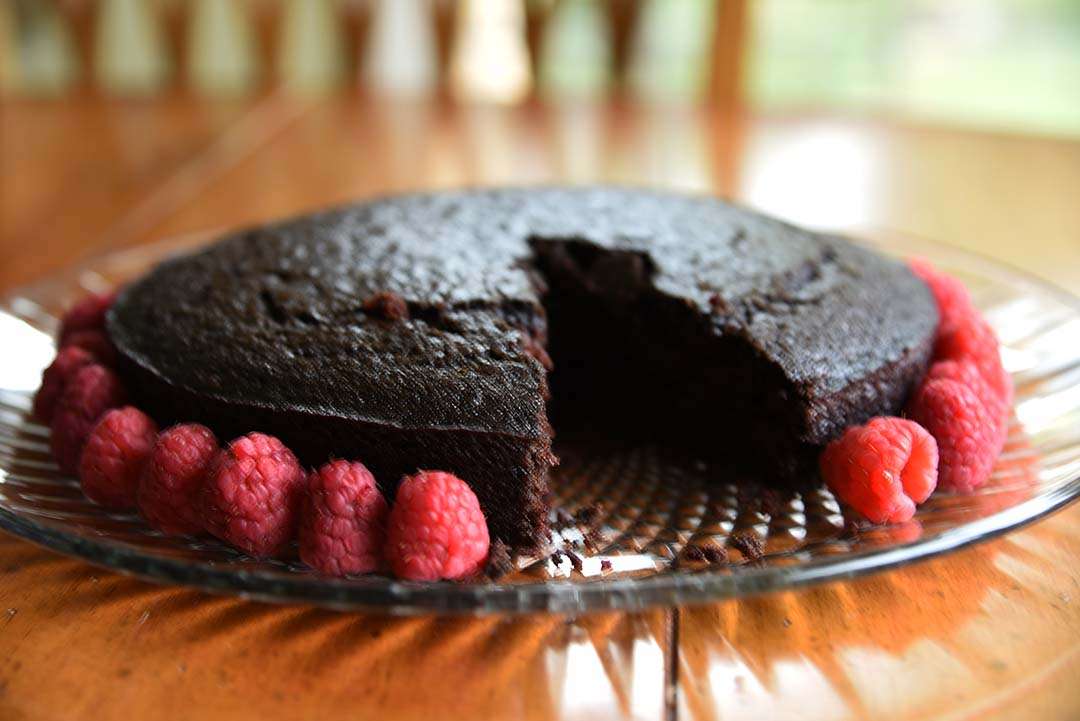 Chocolate Cake with Raspberries for Wine Tasting - Piece cut out of cake